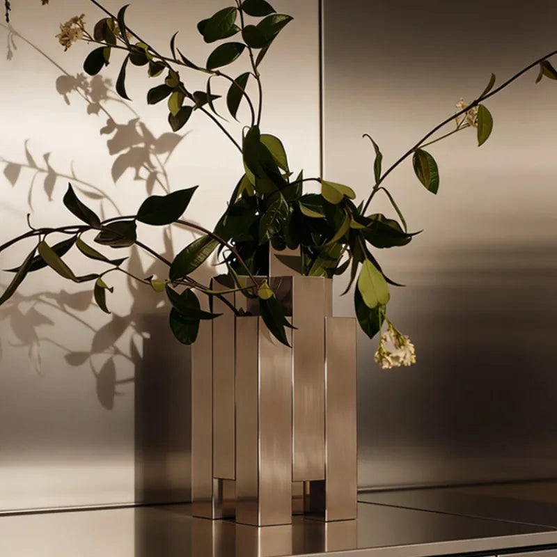 Stylish metallic vase showcasing green leaves and branches with the focus on 'A required field is missing.'